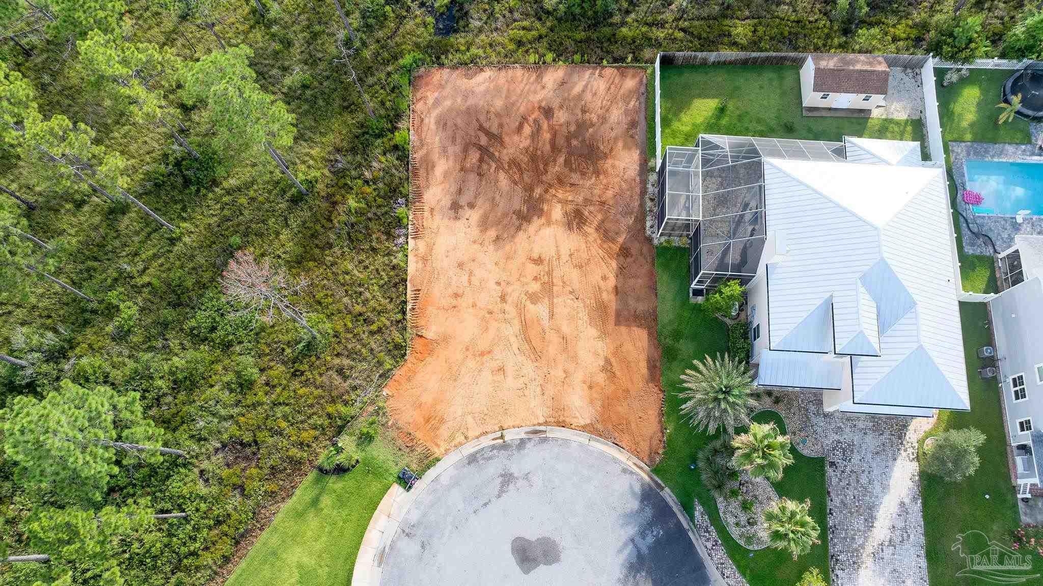 an aerial view of a house with a yard basket ball court and outdoor seating