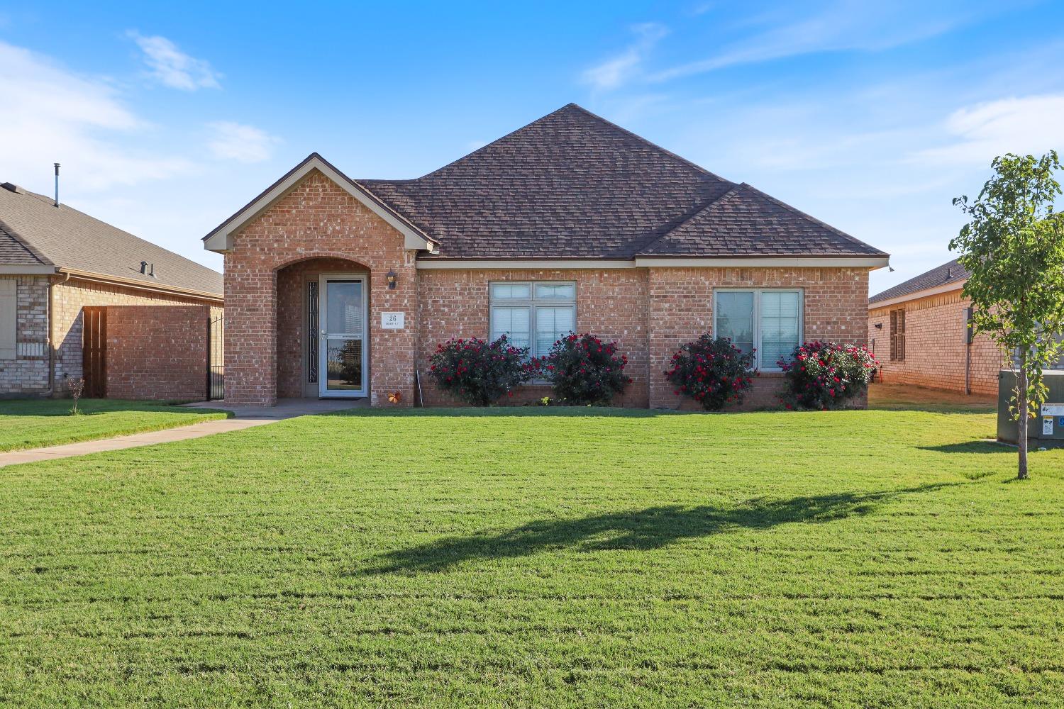 a front view of a house with garden