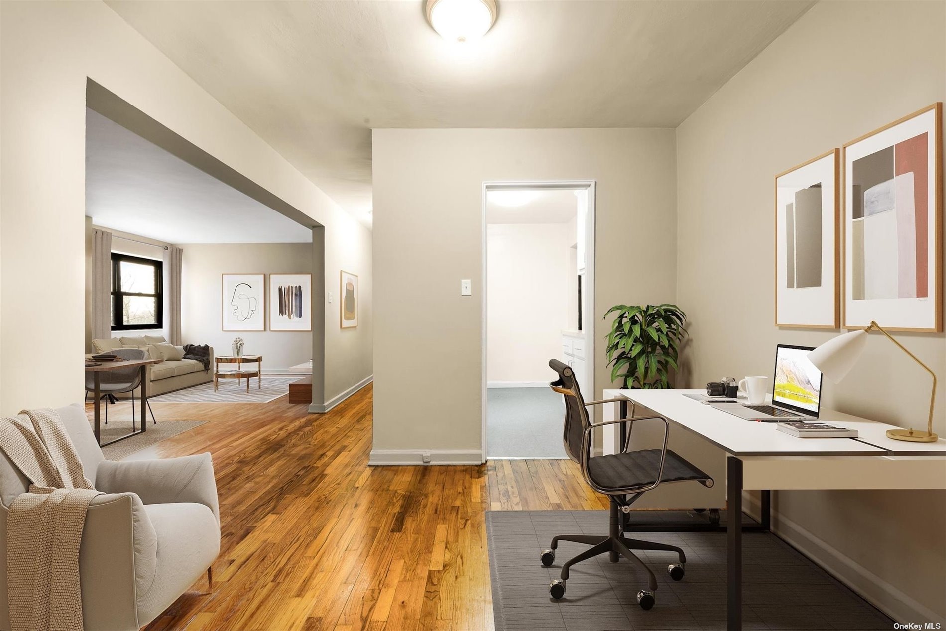 a view of a livingroom with workspace and a couch