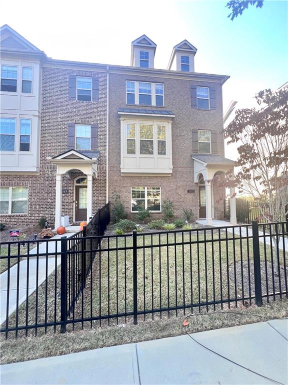 a front view of a house with a fence