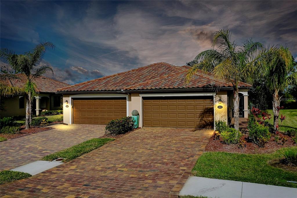 a front view of a house with a yard and garage