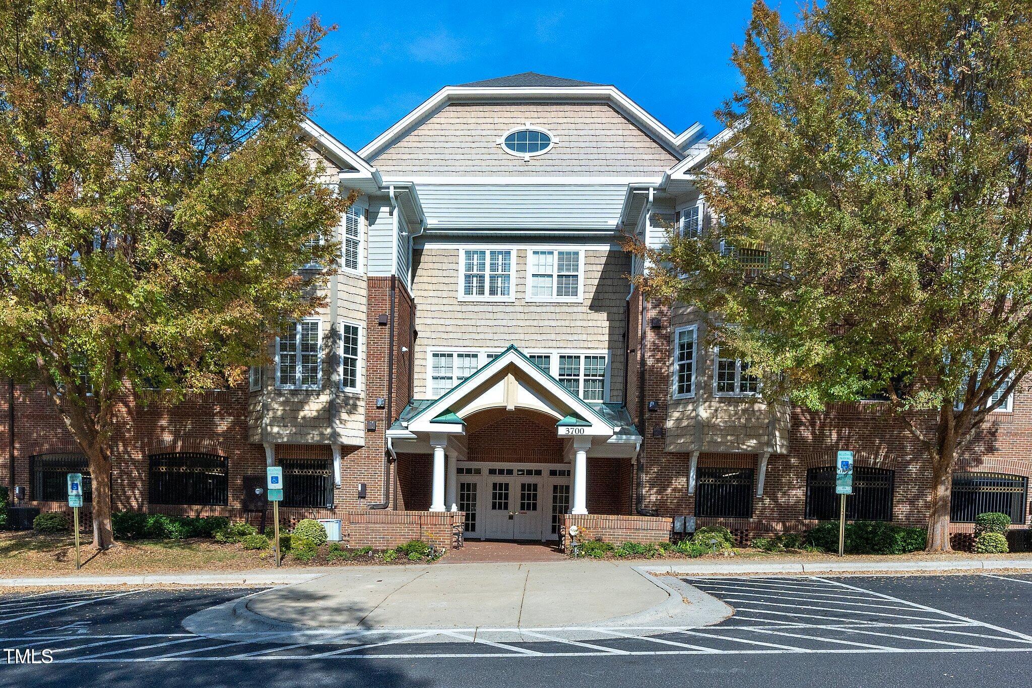 a front view of a building with trees