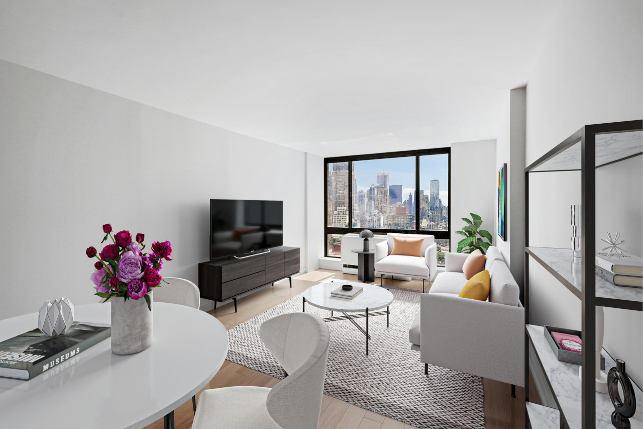 a living room with furniture potted plant and a flat screen tv