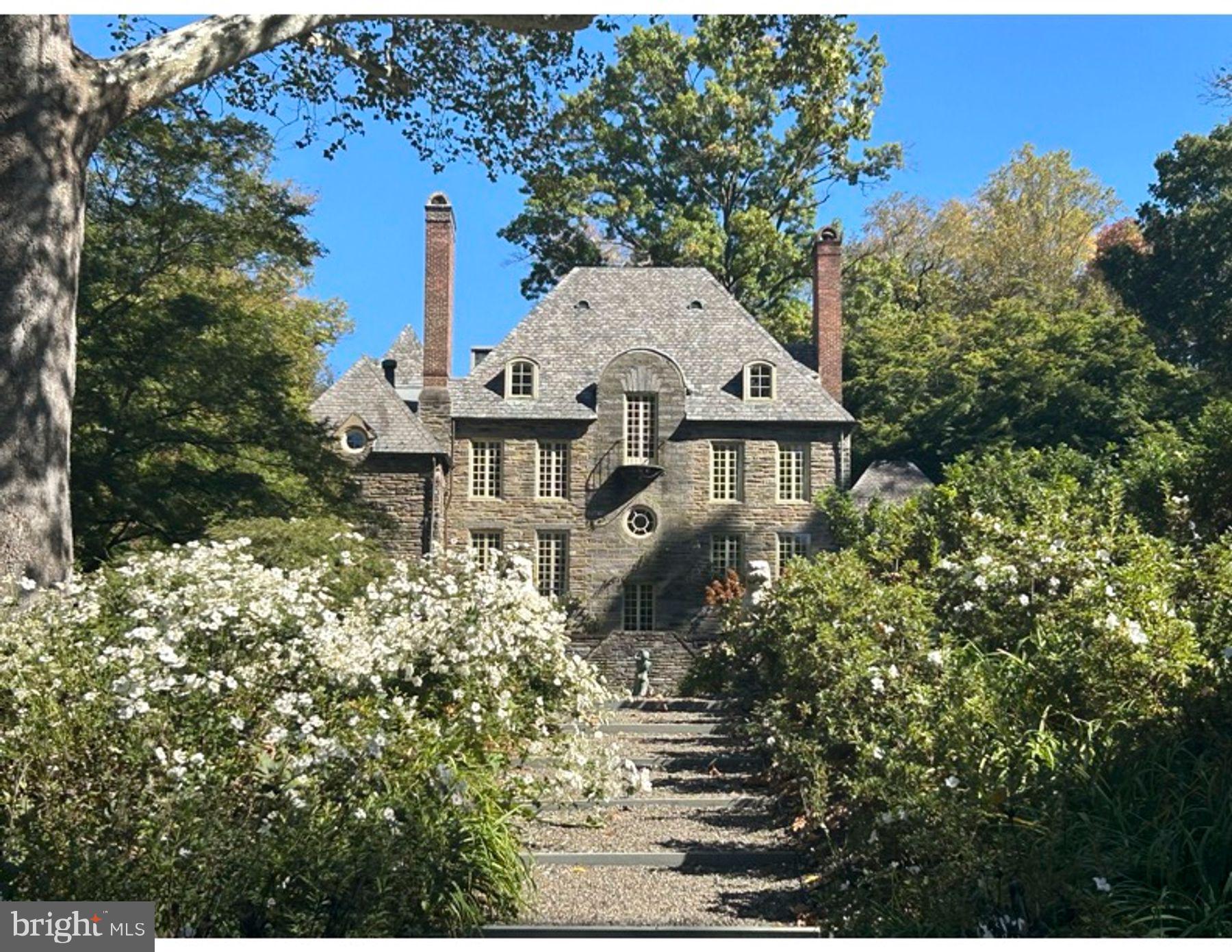 view of a house with a yard and garden