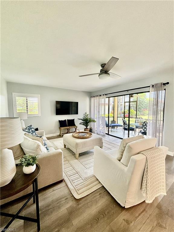 a living room with fireplace furniture and a large window