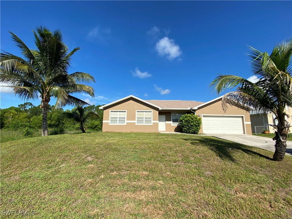 a front view of a house with a yard and garage