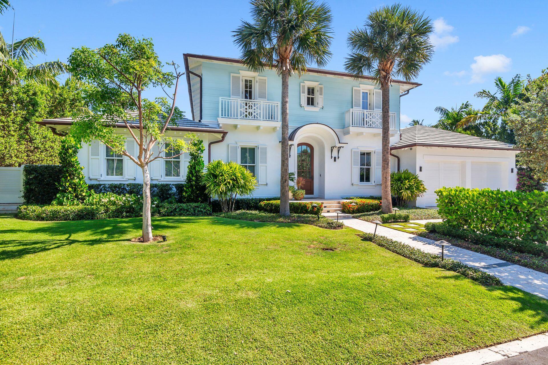 a front view of house with yard and swimming pool