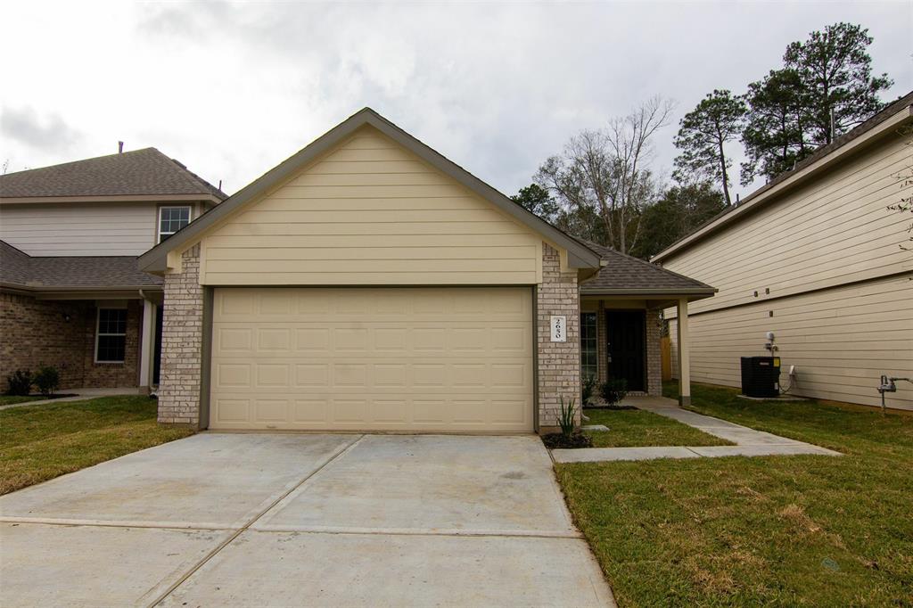 a front view of a house with a yard and garage