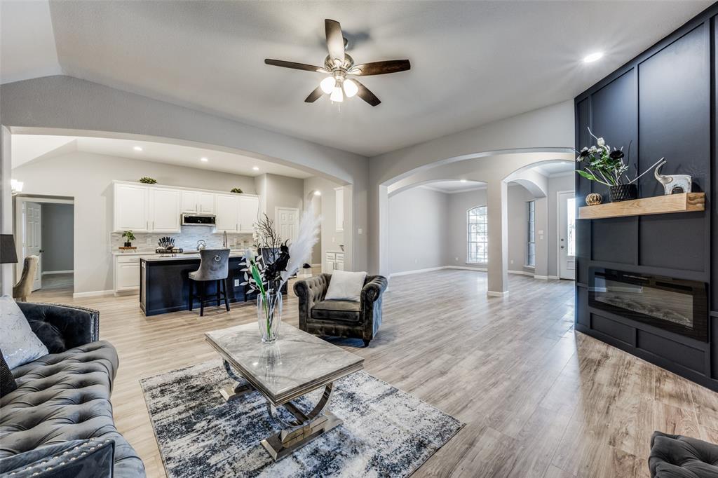 a living room with furniture or chandelier and a wooden floor