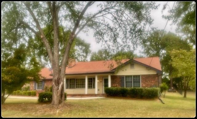 a front view of a house with a garden