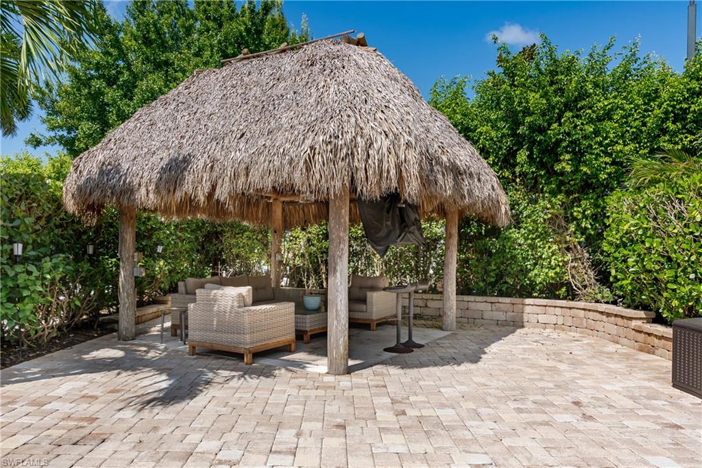 a view of backyard with outdoor seating and trees