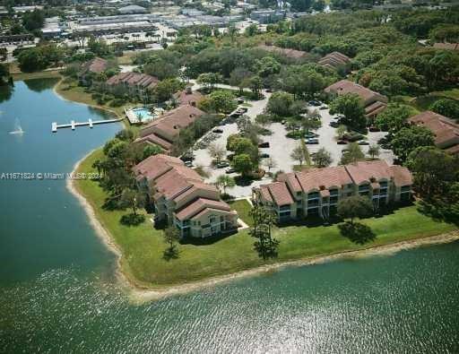 an aerial view of residential houses with outdoor space and trees