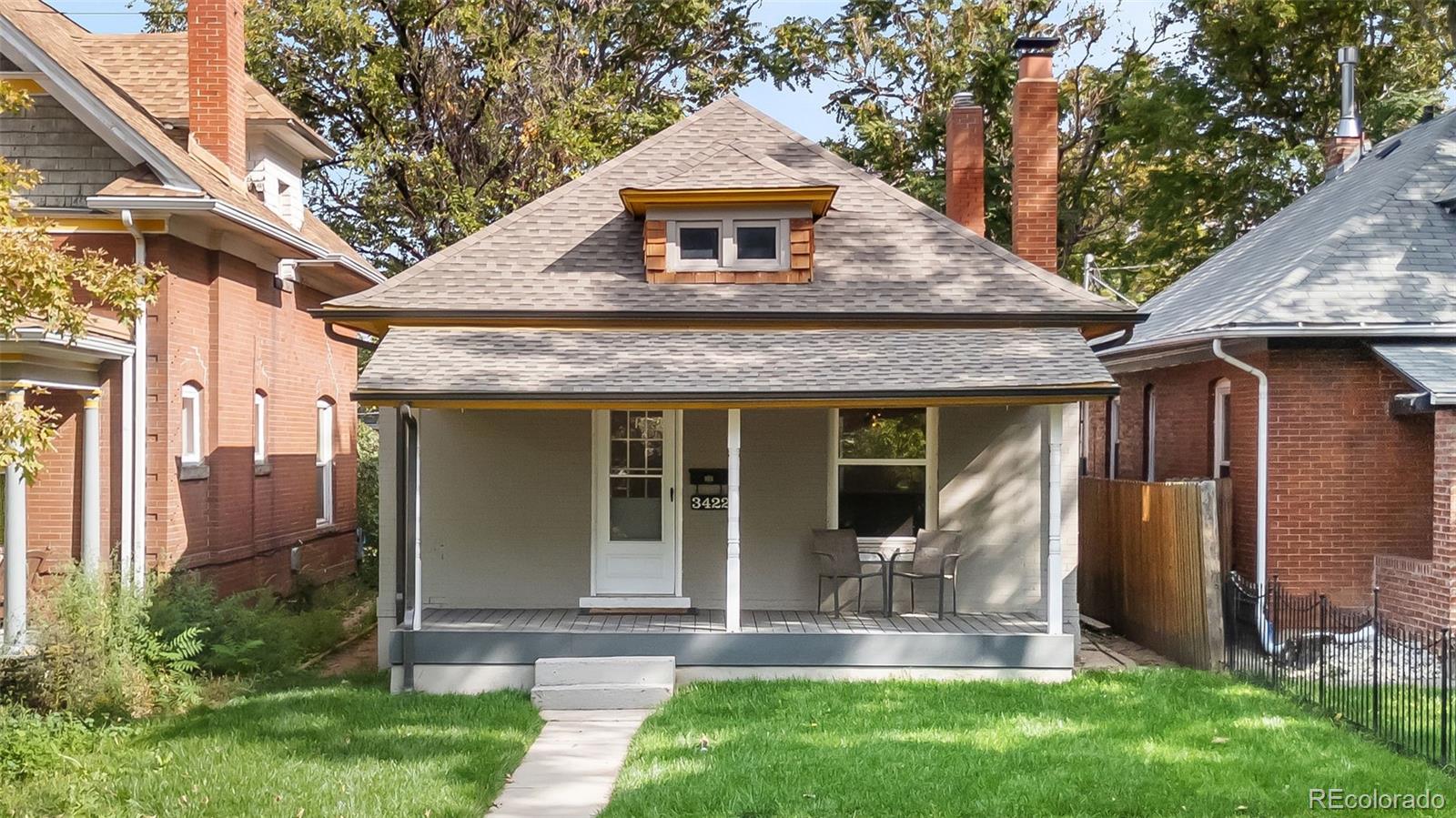 a front view of a house with a yard table and chairs