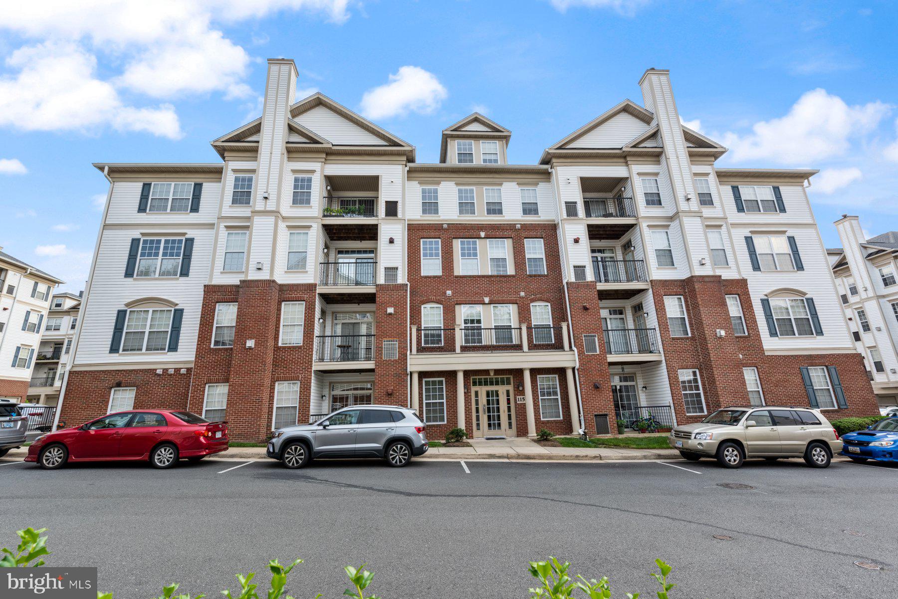 a front view of a residential apartment building with a yard