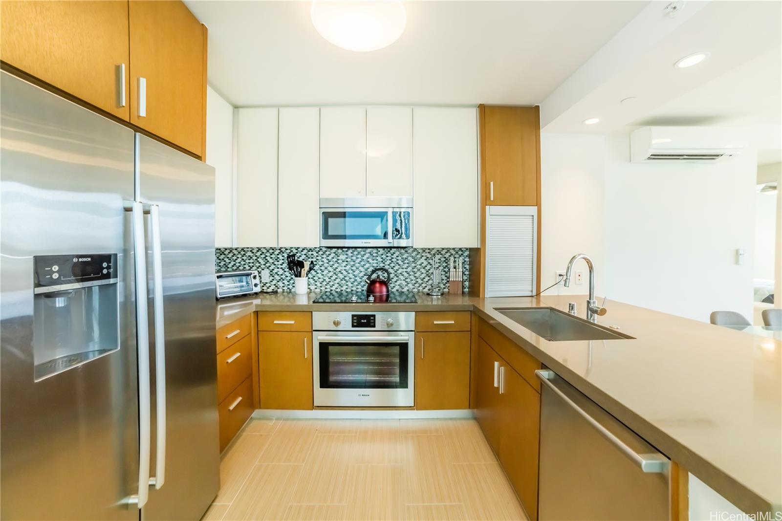 a kitchen with stainless steel appliances granite countertop a sink a stove and refrigerator