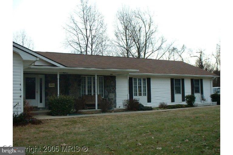 front view of a brick house with a yard