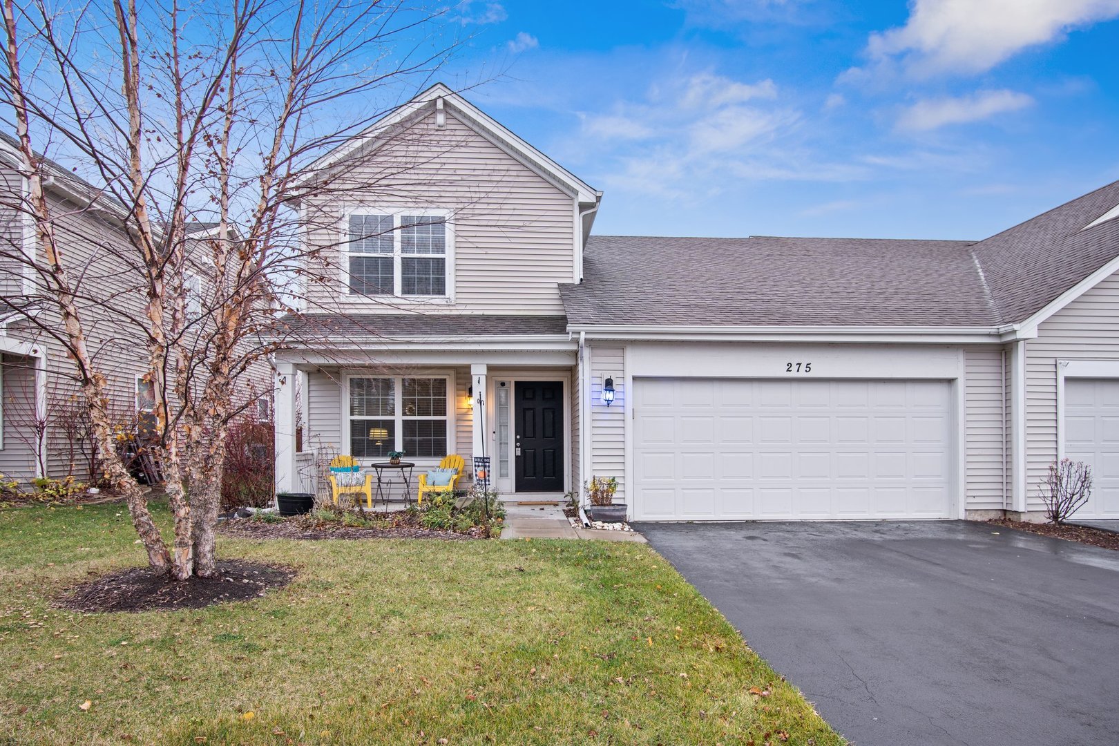 a front view of a house with a yard and garage