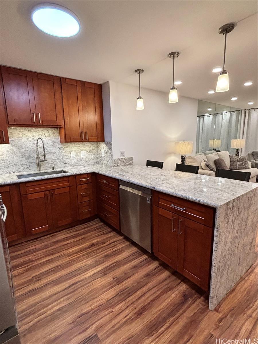 a kitchen with wooden cabinets sink and window