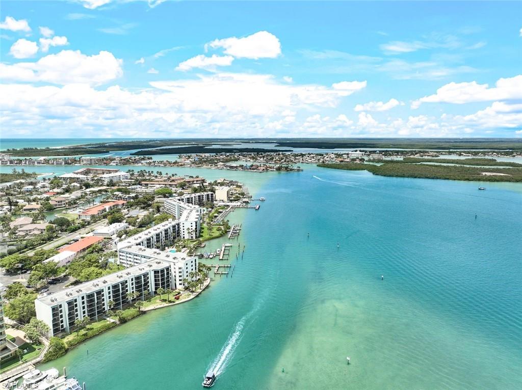 a view of a city with lots of residential buildings ocean and mountain view in back