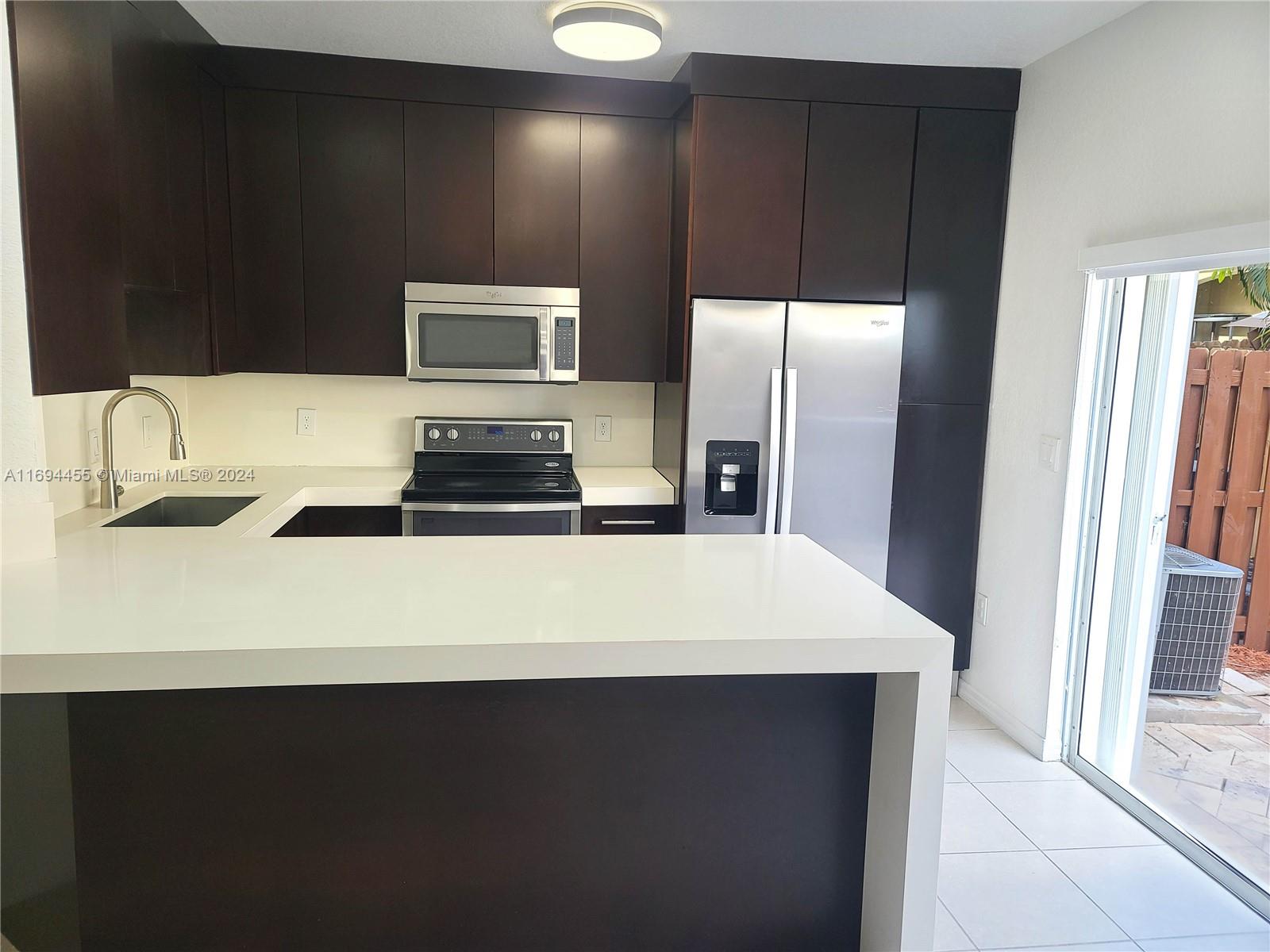 a kitchen with a refrigerator and a sink