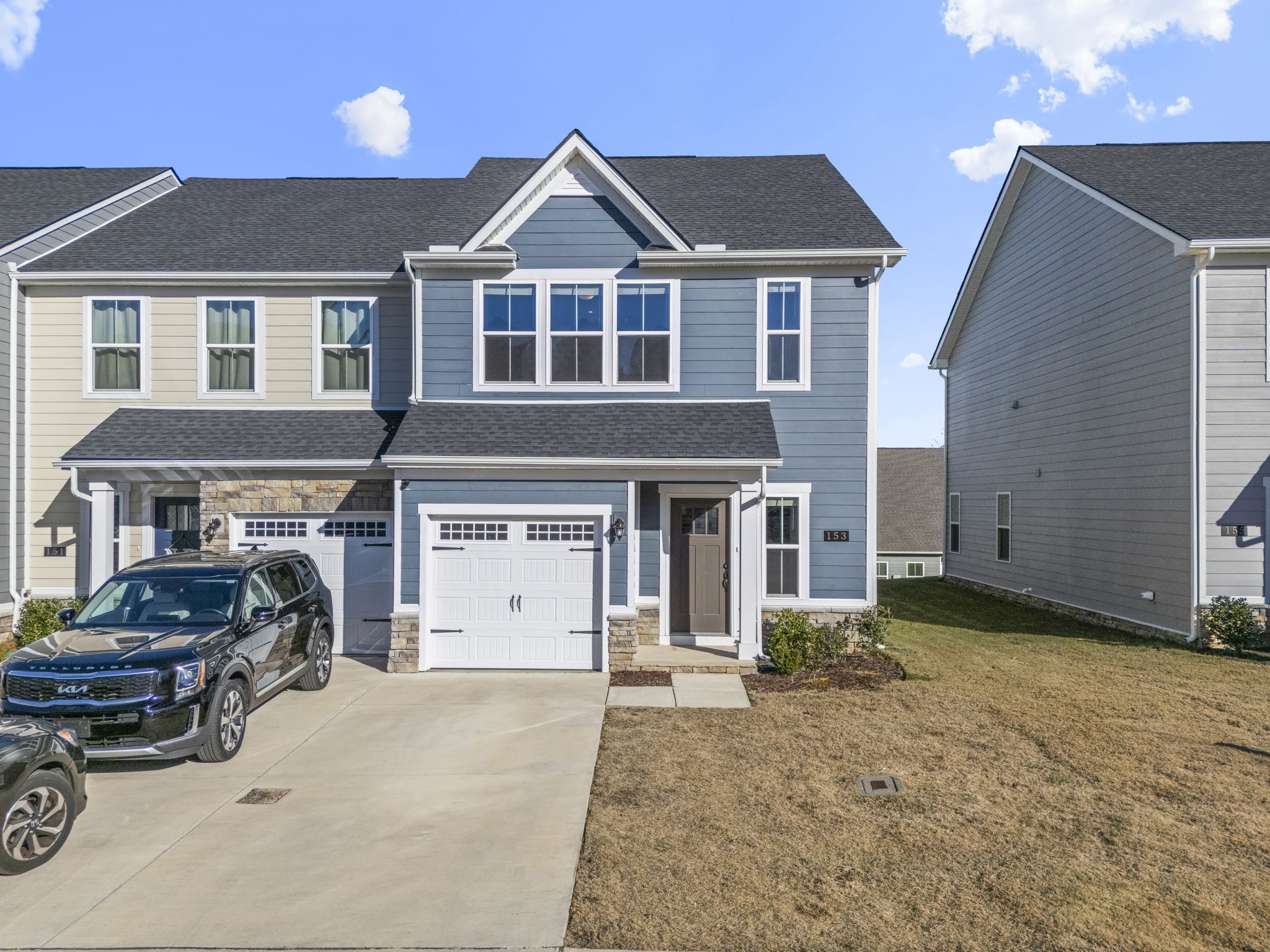 a front view of a house with a yard and garage