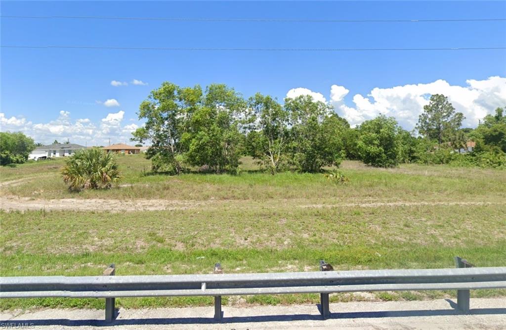 a view of a green yard next to a yard