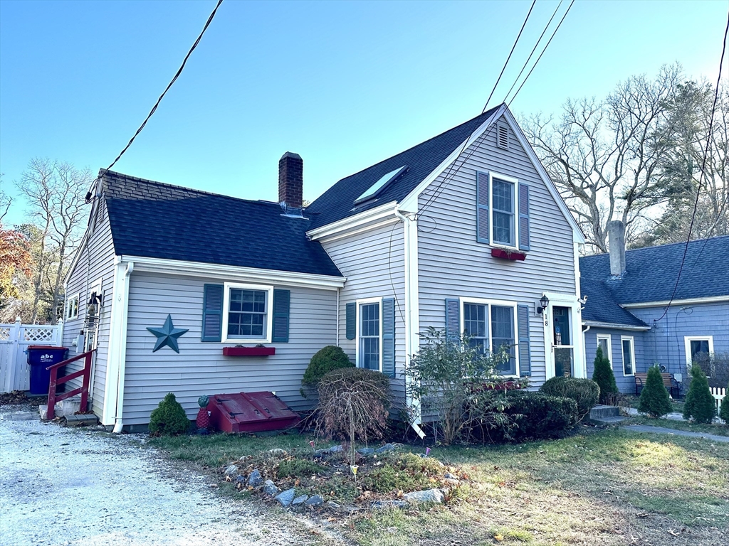 a front view of house with yard and outdoor seating