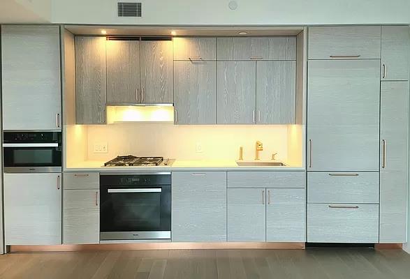 a kitchen with granite countertop a sink and a stove