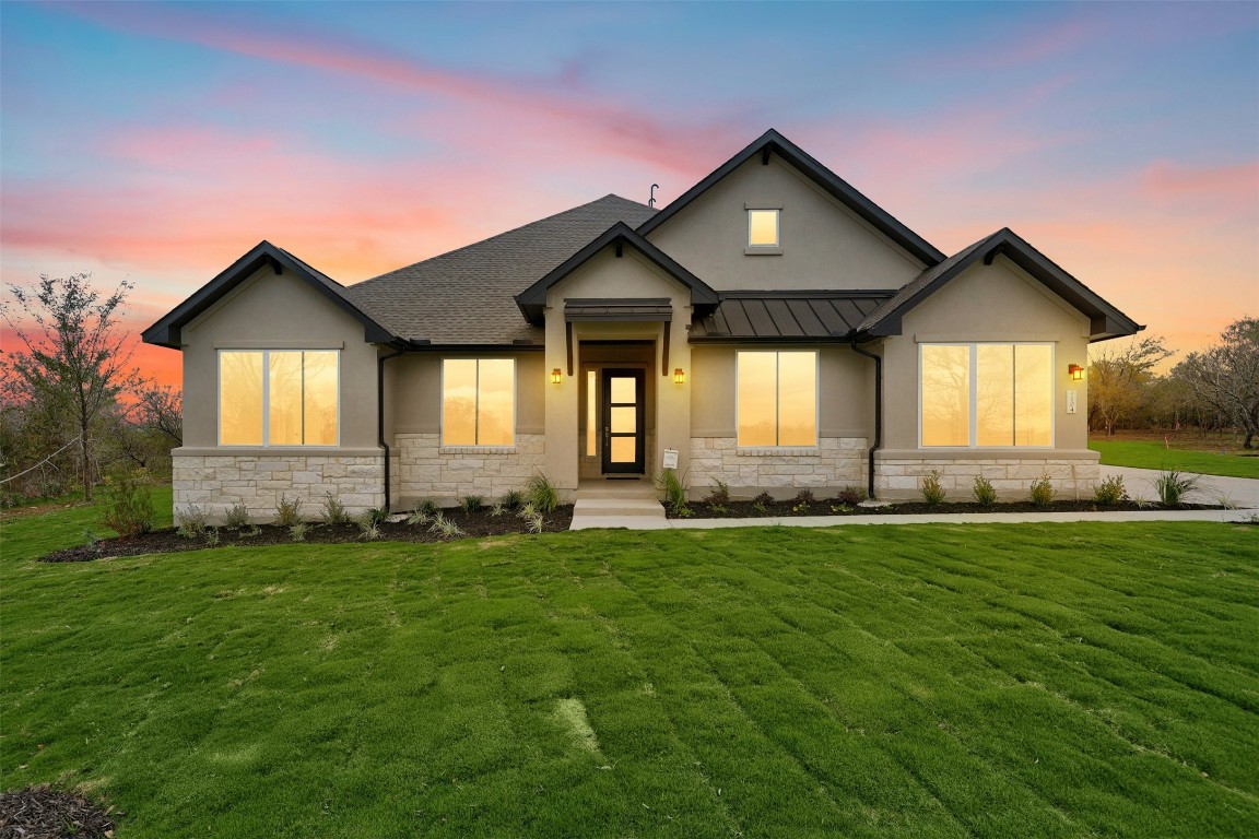 a front view of a house with a yard