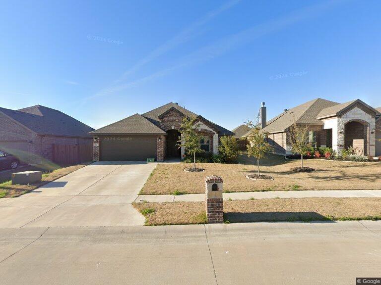 a view of house with a yard and car parked