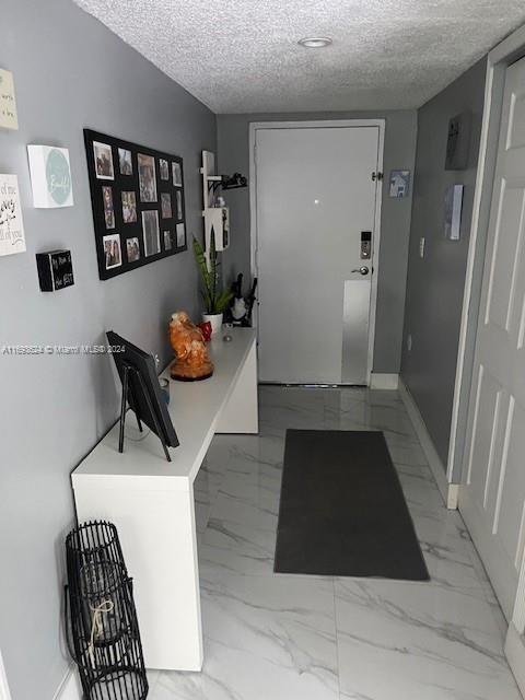 a hallway with table and closet