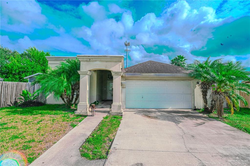 View of front of house featuring a garage and a front lawn