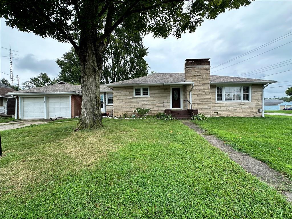 a front view of house with yard and green space