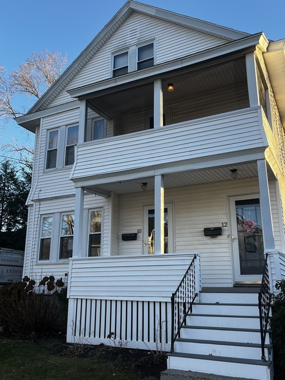 a view of a house with wooden deck