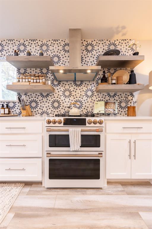 a stove top oven sitting inside of a kitchen