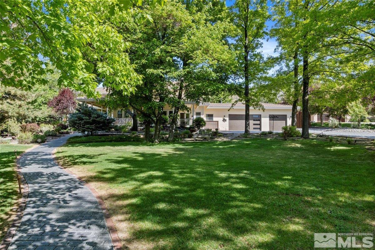 a view of a house with a backyard