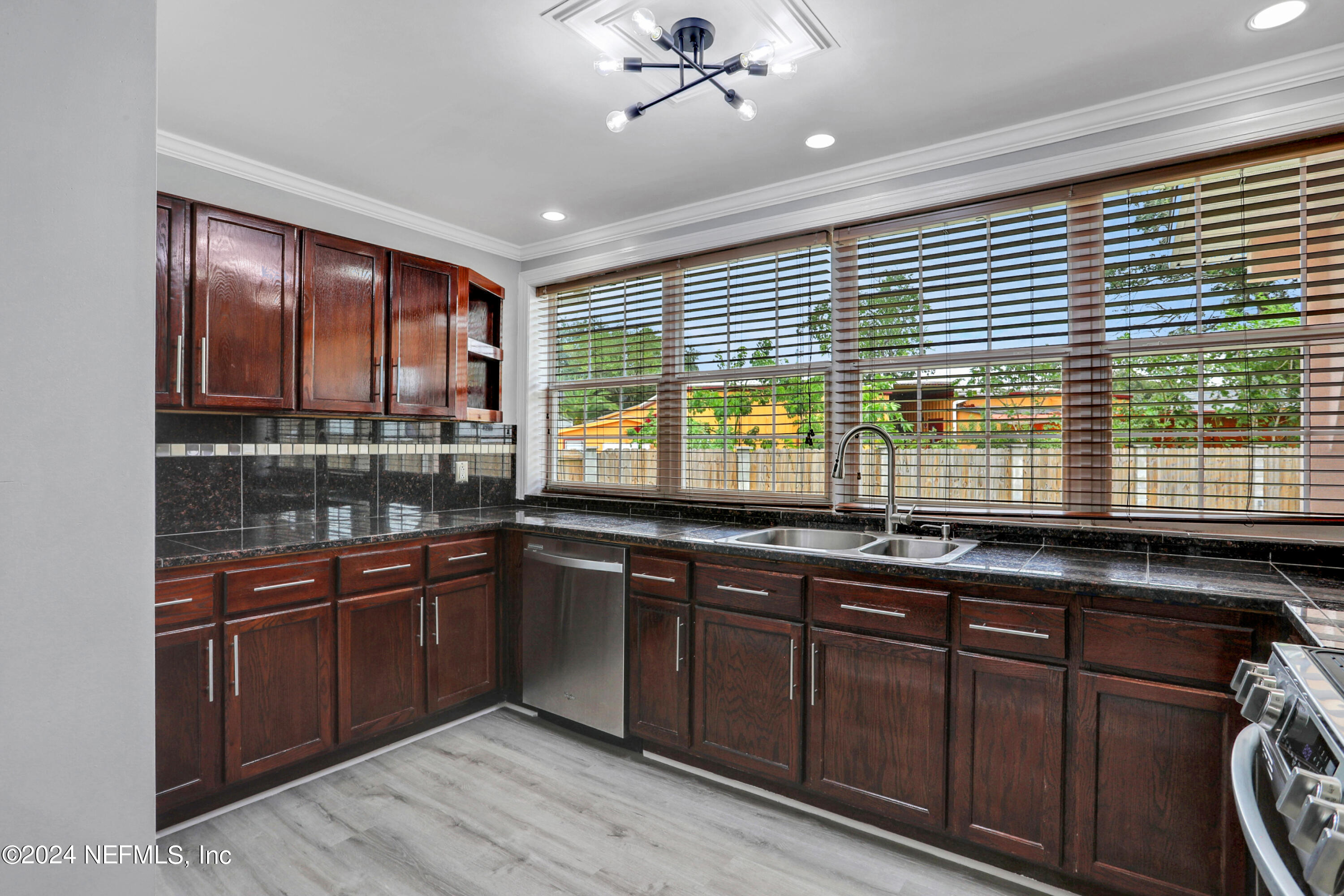 a kitchen with stainless steel appliances granite countertop a stove and cabinets