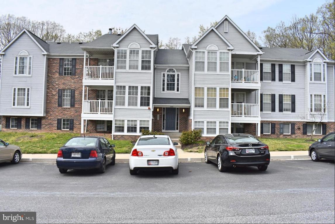 a car parked in front of a big house