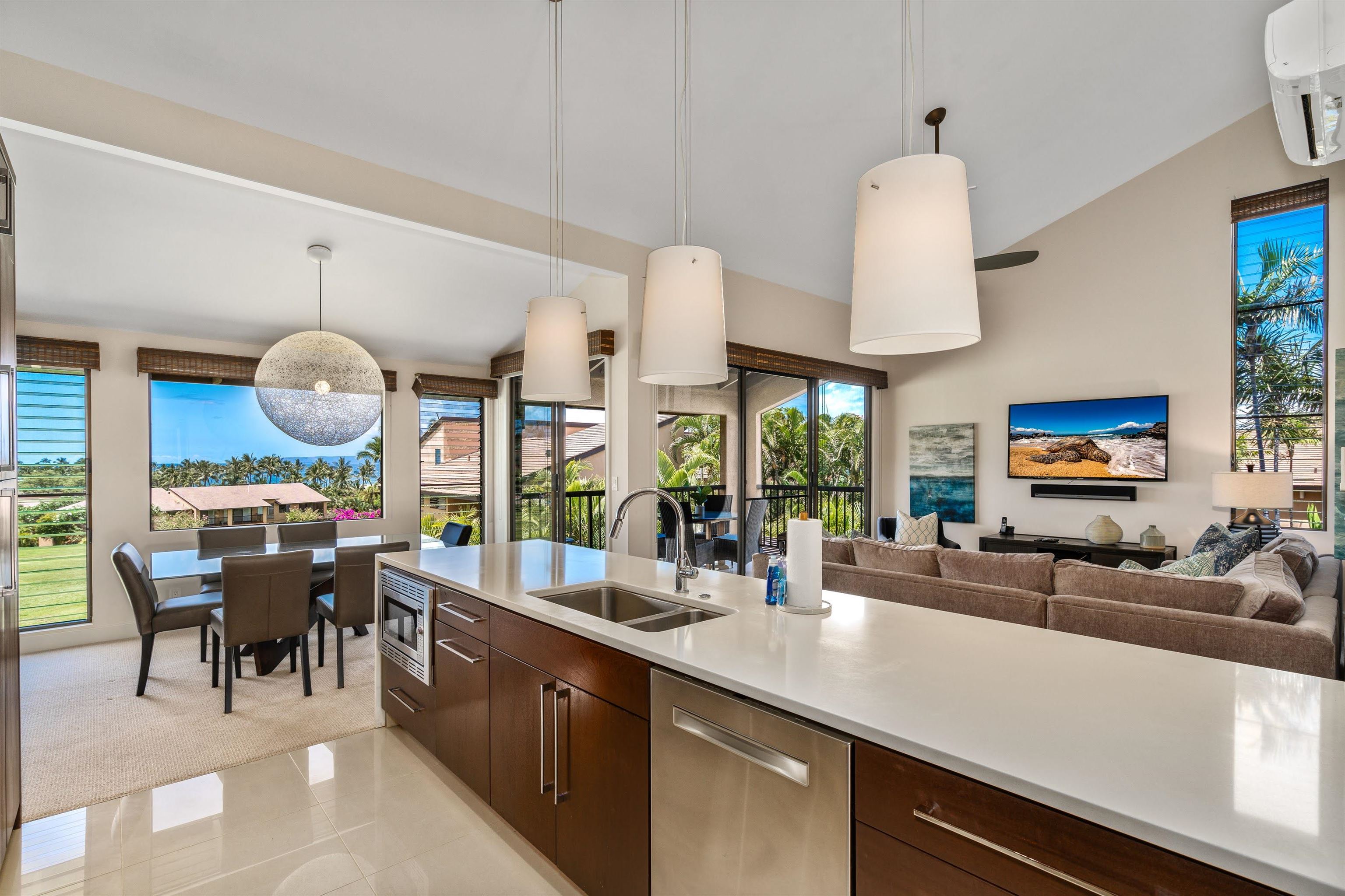 a kitchen with stainless steel appliances granite countertop a sink and a large window