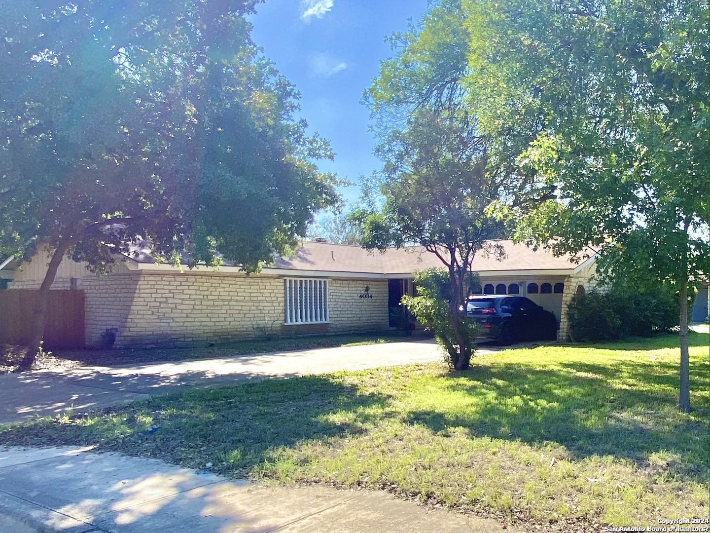 a view of a house with a yard and a patio