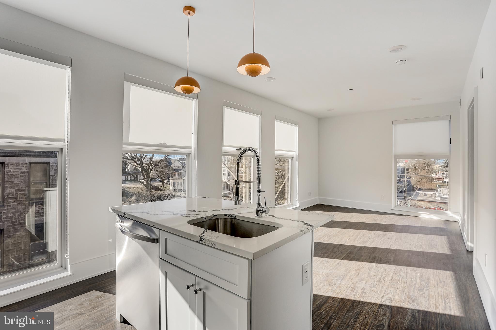 a kitchen with a sink a stove and a window