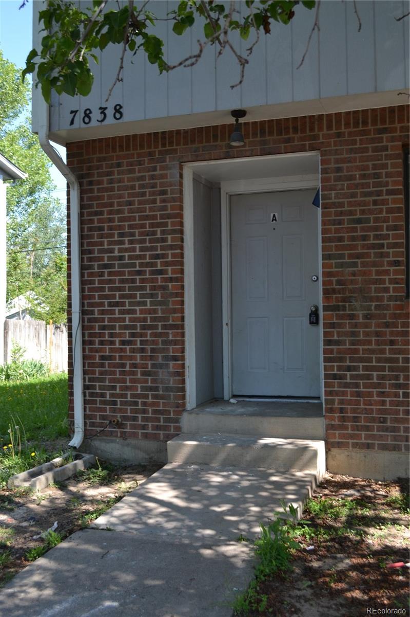 a brick building with a door and a window