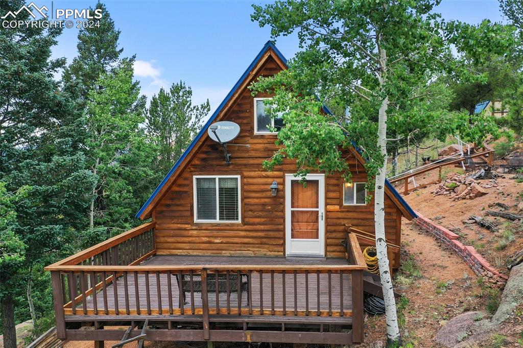 a backyard of a house with wooden floor fence and deck