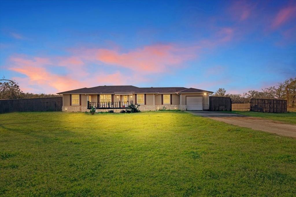 a front view of a house with a big yard