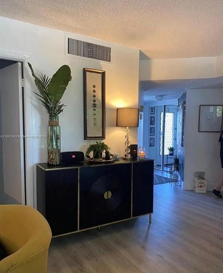 a living room with couches and wooden floor