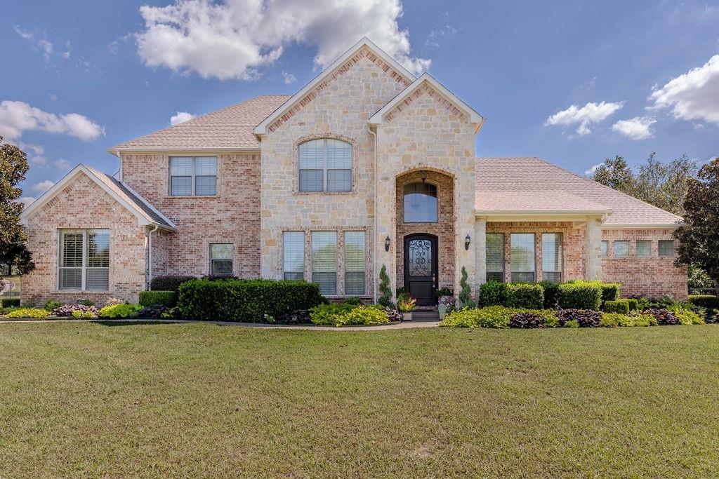 a front view of a house with a yard