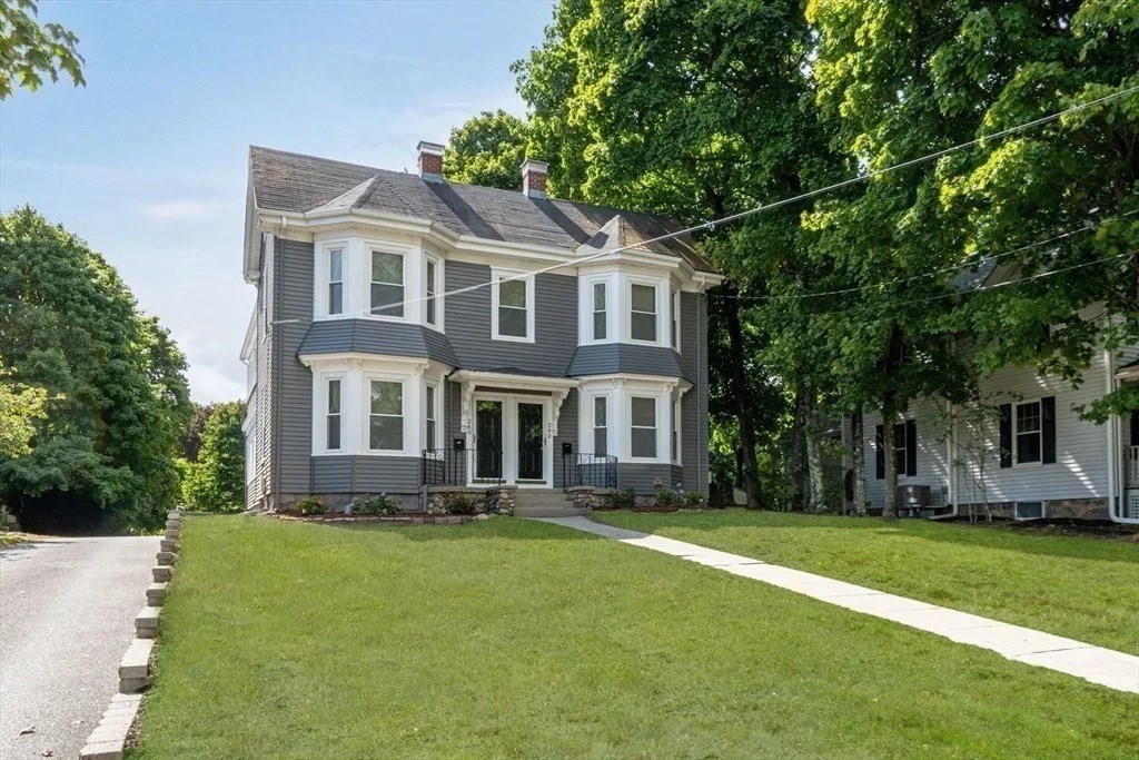 a front view of house with yard and green space