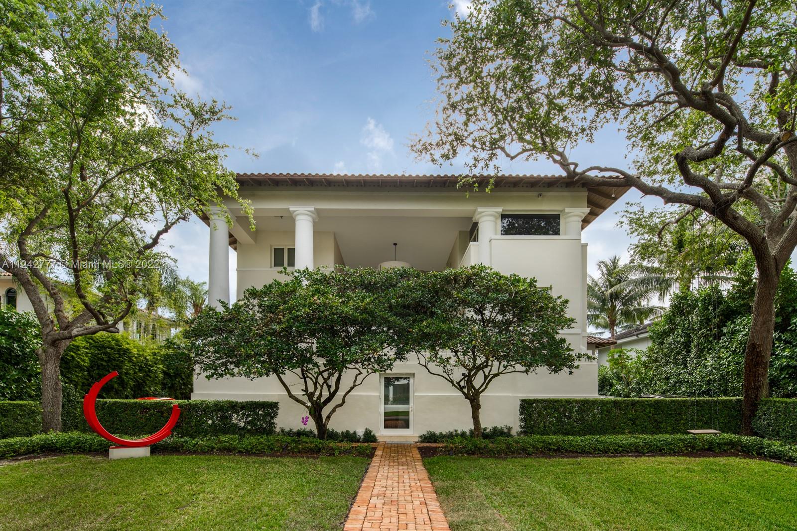 a front view of house with yard and green space