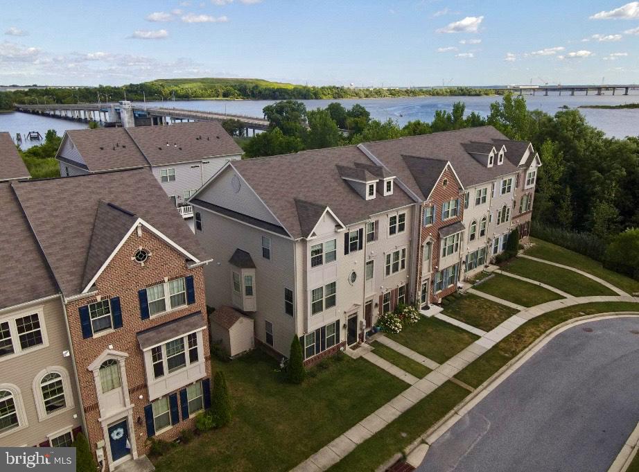 an aerial view of multiple houses with a yard