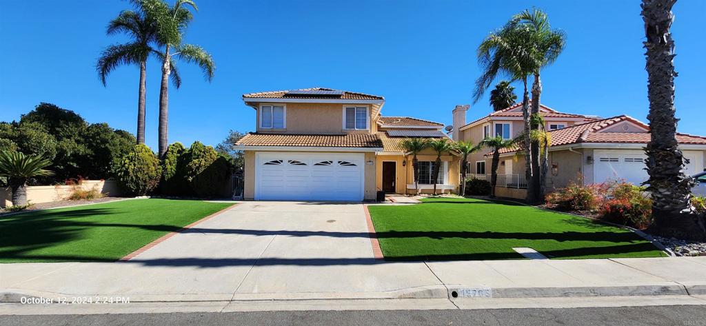 a front view of a house with a garden and yard